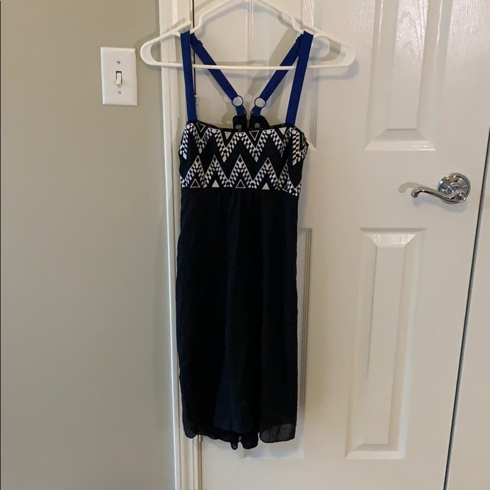 Black cocktail dress with blue straps.